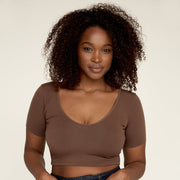 Woman wearing The Crop undershirt from Numi in deep brown